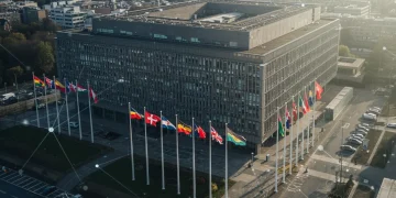 NATO headquarters building with member state flags, symbolizing international defense and cooperation