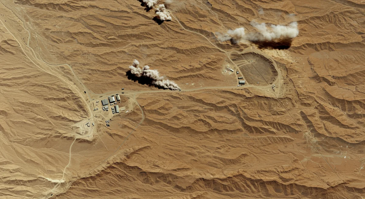 Satellite view of remote conflict zone in arid landscape with military presence